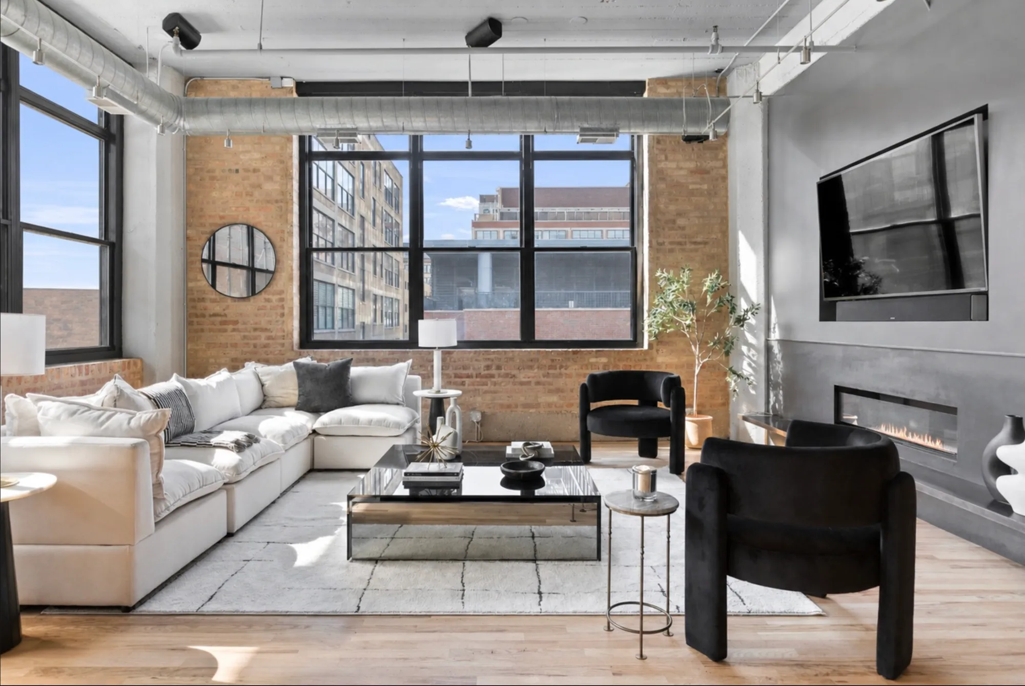 A staged loft living room in Chicago by Studio Ikos